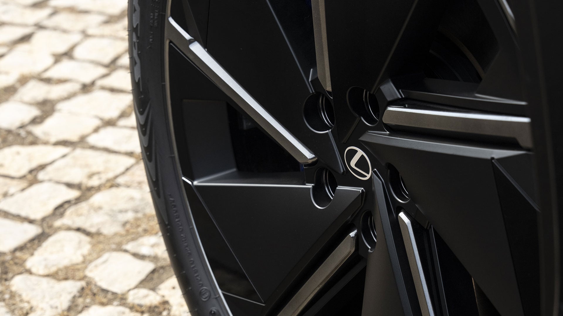 Close-up of Lexus alloy wheel with black multi-spoke design
