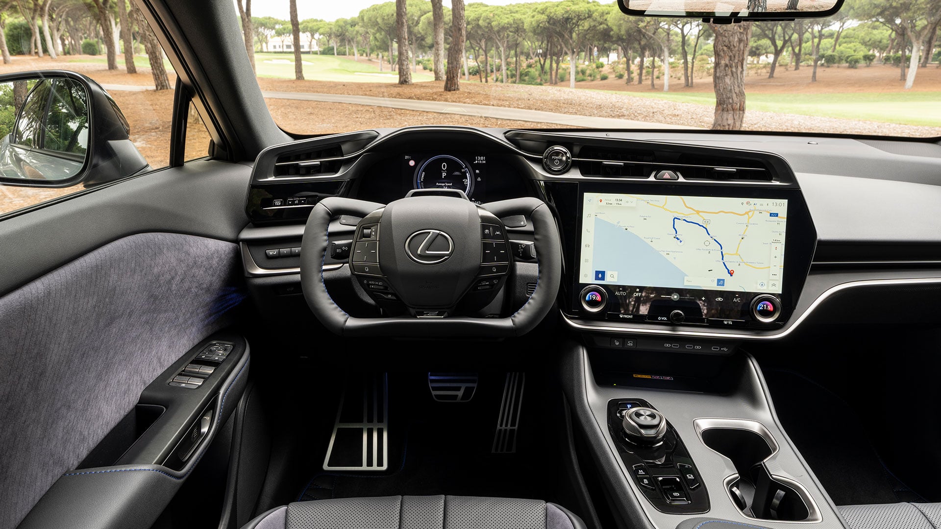 Interior view of Lexus RZ cockpit with steering wheel and touchscreen display