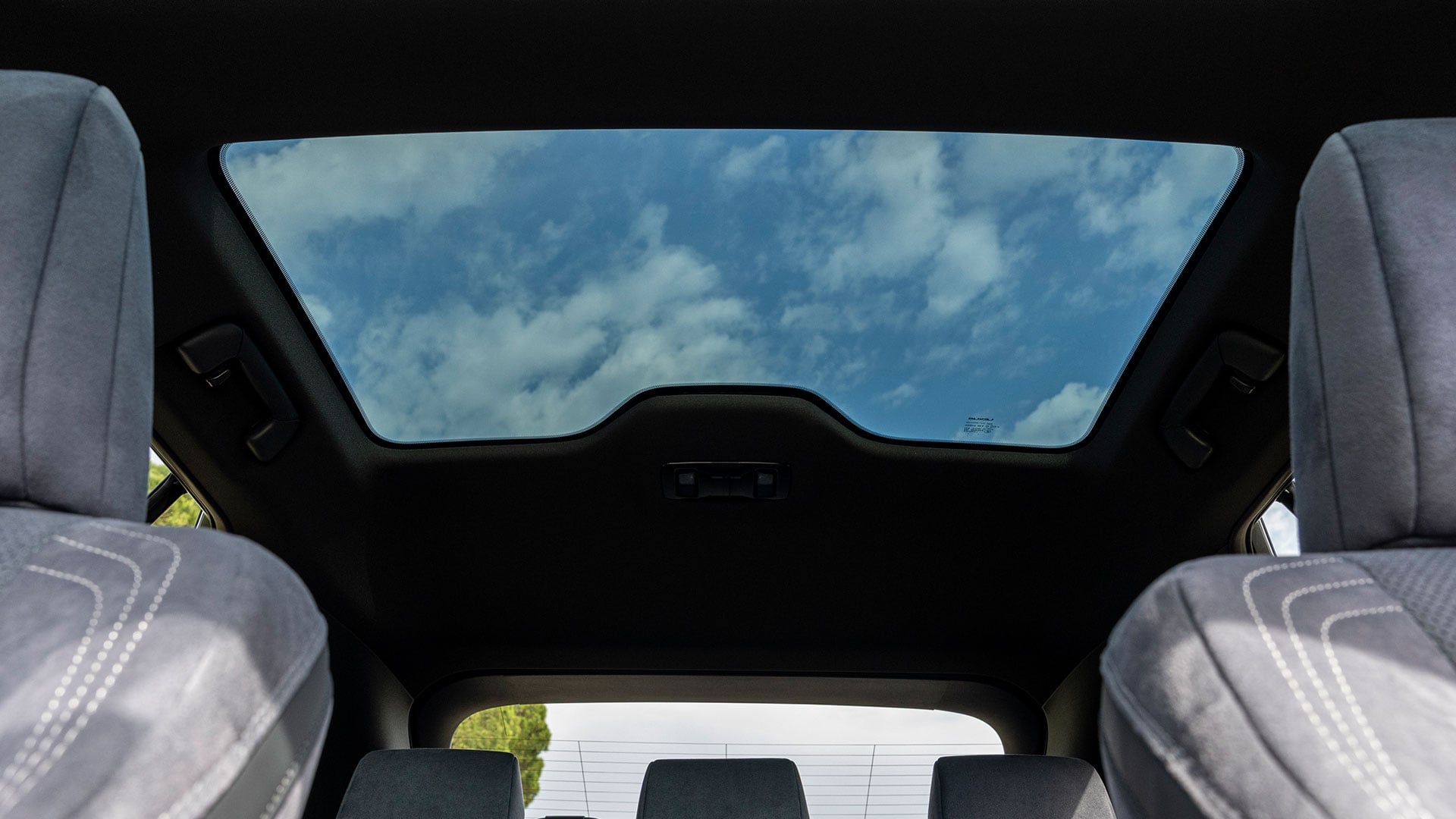 Lexus RZ panoramic roof in transparent mode with clear sky view