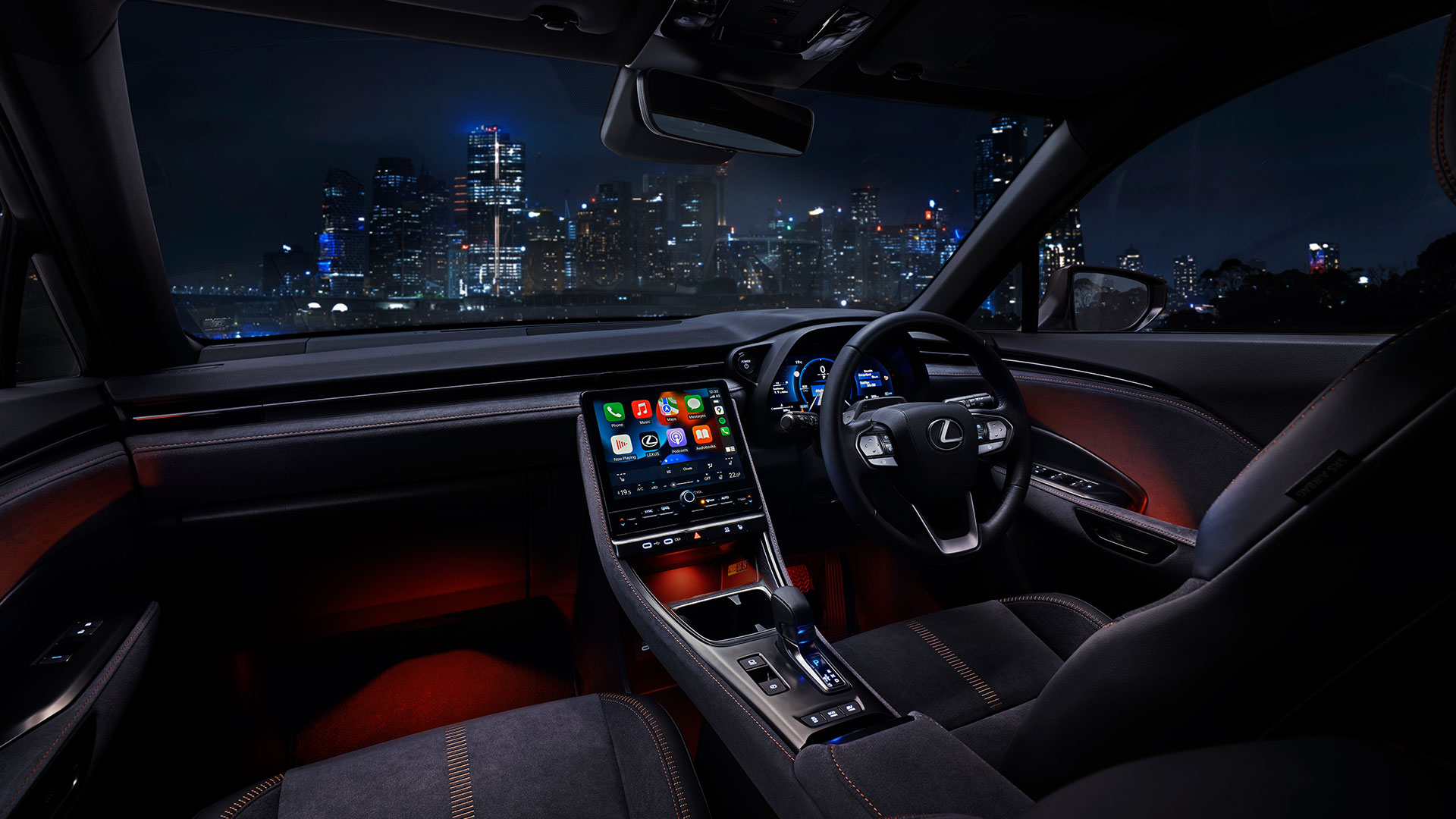 Red Lexus LBX 06 luxury multi-colour interior Illumination light parked facing night city scape