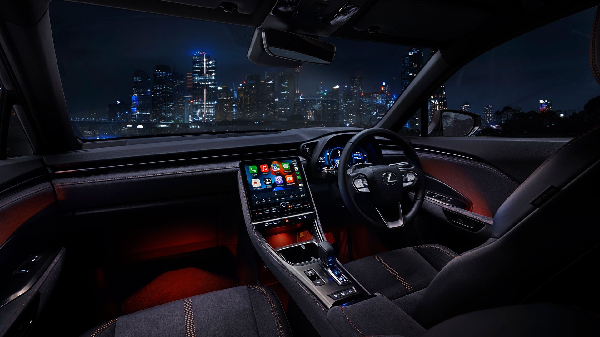 Red Lexus LBX 06 luxury multi-colour interior Illumination light parked facing night city scape